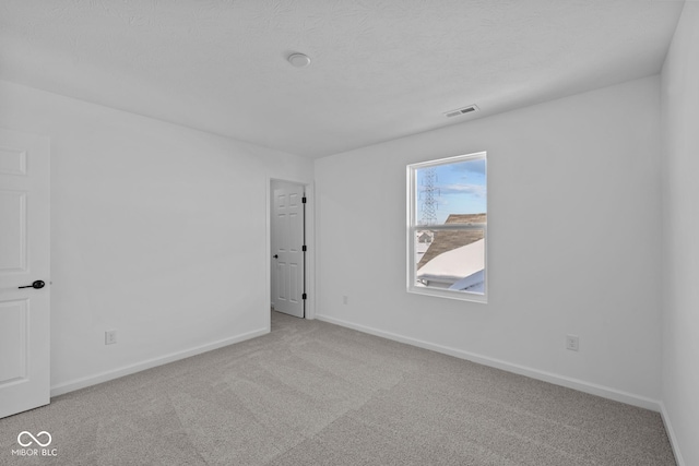 unfurnished room featuring carpet floors and a textured ceiling