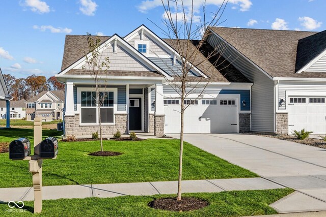 10618 Maidenhair Dr, Indianapolis, IN 46239 - craftsman inspired home with stone siding, a garage, concrete driveway, and a front lawn