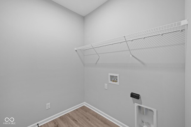 10618 Maidenhair Dr, Indianapolis, IN 46239 - washroom featuring hookup for a washing machine, wood finished floors, baseboards, and hookup for an electric dryer