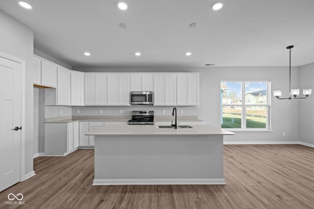 10618 Maidenhair Dr, Indianapolis, IN 46239 - kitchen with appliances with stainless steel finishes, a sink, light wood-type flooring, light countertops, and baseboards