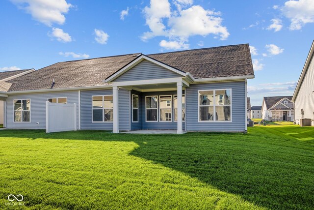10618 Maidenhair Dr, Indianapolis, IN 46239 - back of house with a lawn, a patio area, and roof with shingles