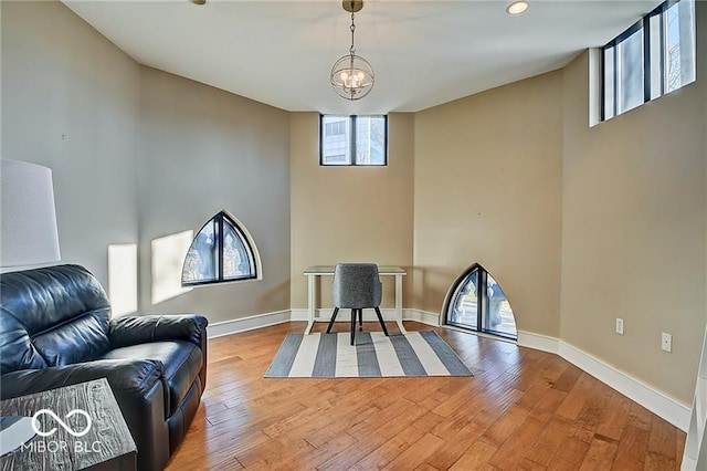 living area featuring wood-type flooring and lofted ceiling