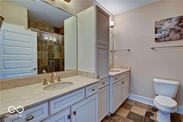 bathroom with vanity, a shower with shower door, and toilet