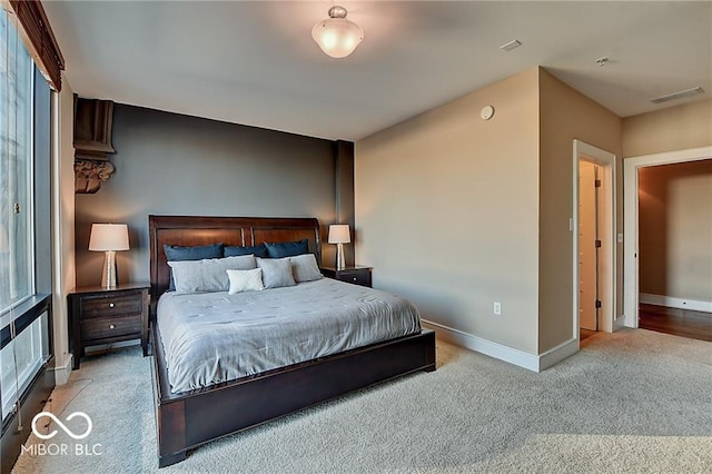 bedroom featuring light carpet