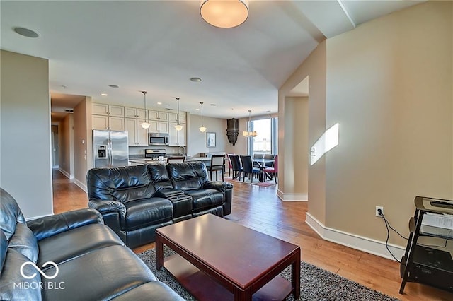 living room with light hardwood / wood-style flooring and sink