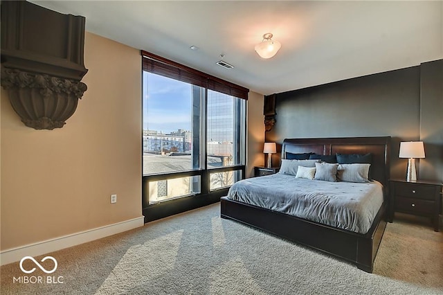 bedroom featuring carpet and multiple windows