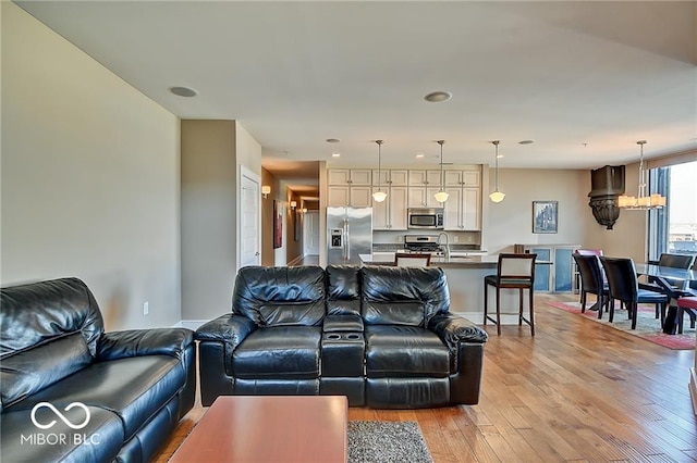 living room featuring light wood-type flooring and sink