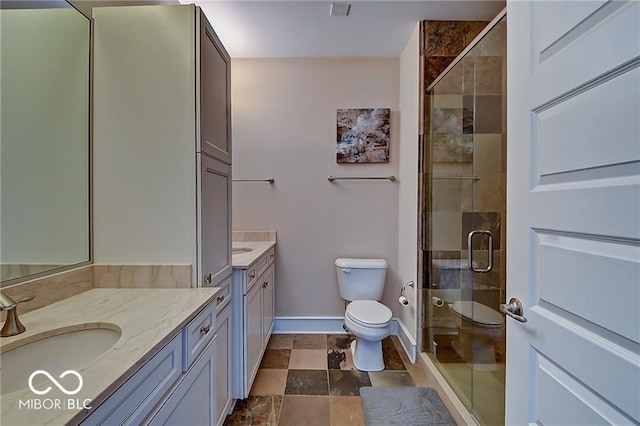 bathroom with walk in shower, vanity, and toilet