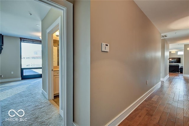 hallway with light hardwood / wood-style flooring