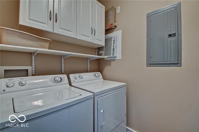 laundry area featuring cabinets, electric panel, and washer and dryer