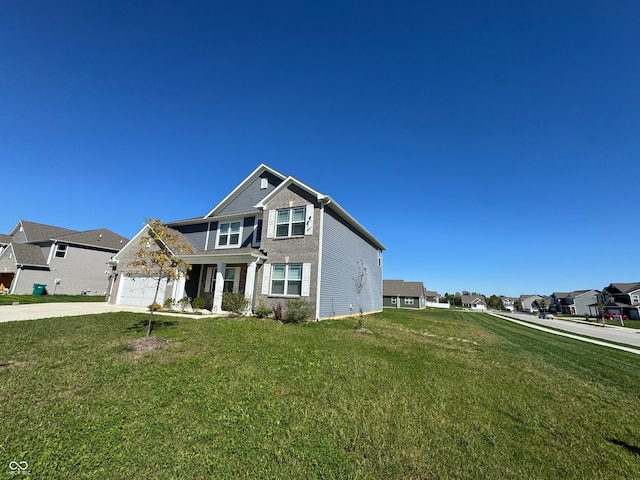 view of front of house featuring a garage and a front yard