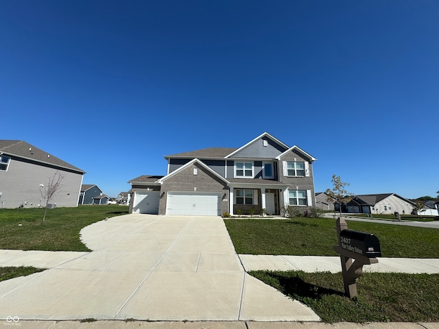 view of front of house with a garage and a front lawn