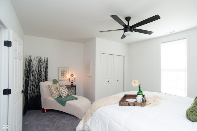 bedroom with carpet floors, ceiling fan, and a closet