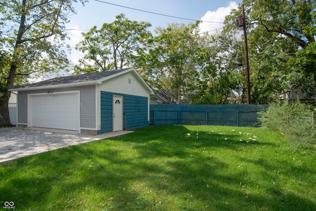 view of yard featuring a garage and an outbuilding