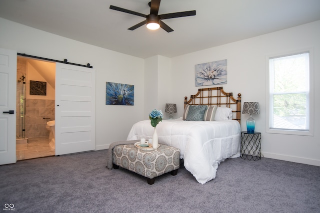 carpeted bedroom featuring ensuite bath, ceiling fan, and a barn door