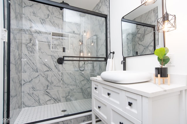 bathroom featuring vanity and a shower with door