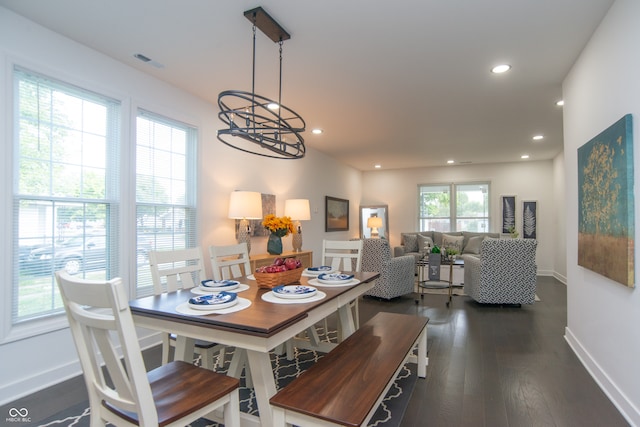 dining room featuring dark wood-type flooring and a notable chandelier