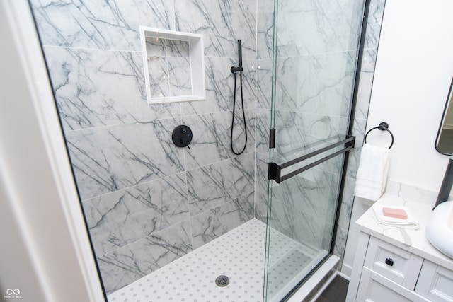 bathroom featuring vanity and a tile shower