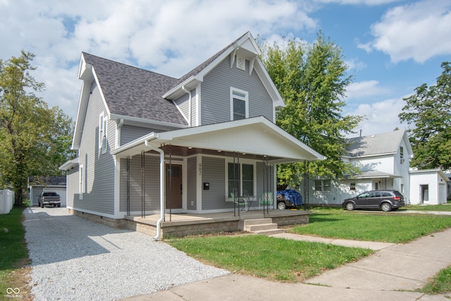 view of property featuring a front lawn and covered porch