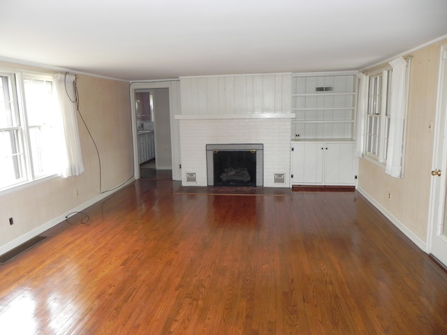 unfurnished living room with a fireplace and dark hardwood / wood-style floors