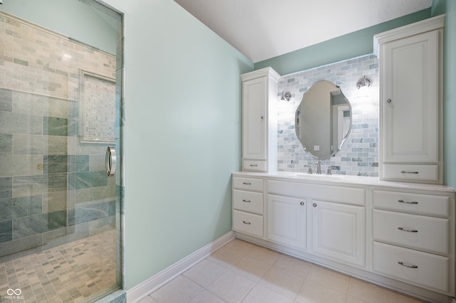 bathroom with tasteful backsplash, walk in shower, tile patterned floors, and vanity