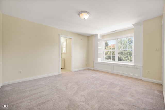 empty room featuring light carpet