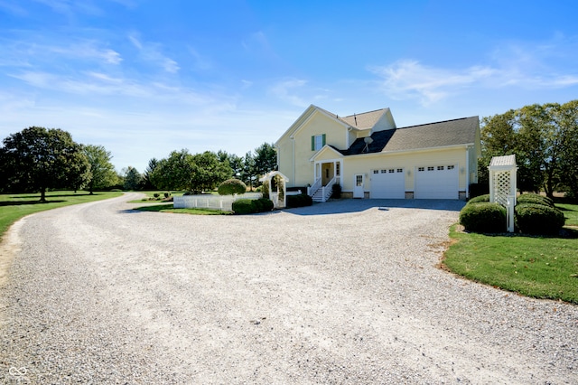 view of front of property featuring a garage and a front yard