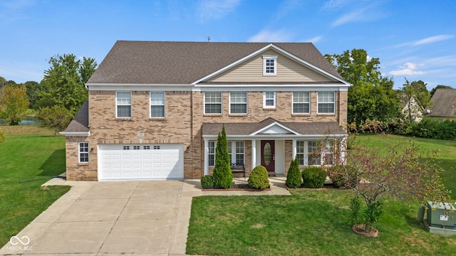 view of front of house featuring a garage and a front lawn