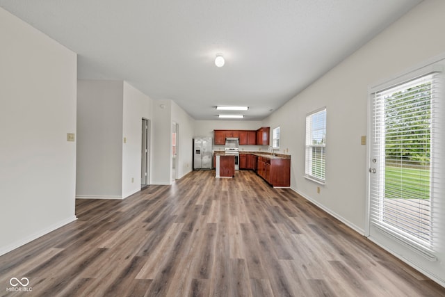 kitchen featuring stainless steel appliances and dark hardwood / wood-style floors