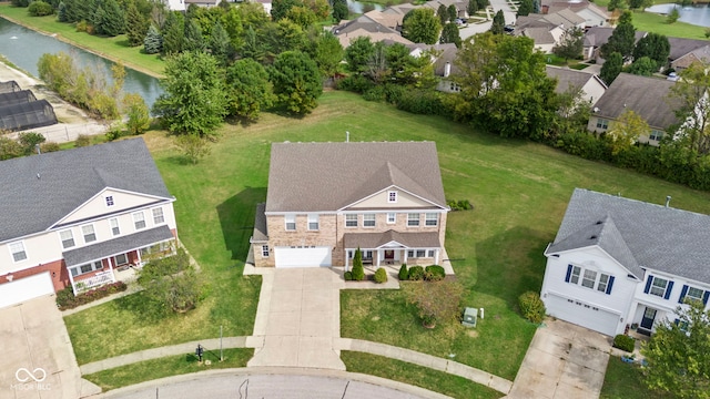 birds eye view of property with a water view