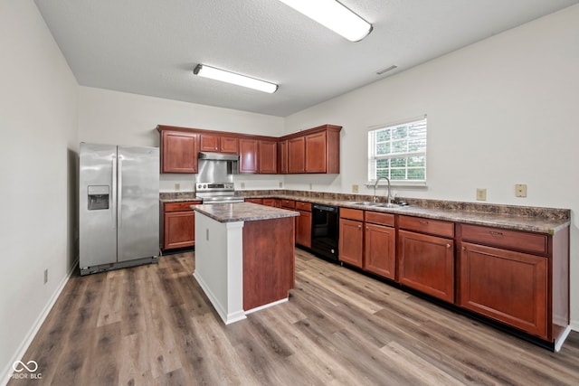 kitchen with a center island, appliances with stainless steel finishes, dark hardwood / wood-style floors, and sink