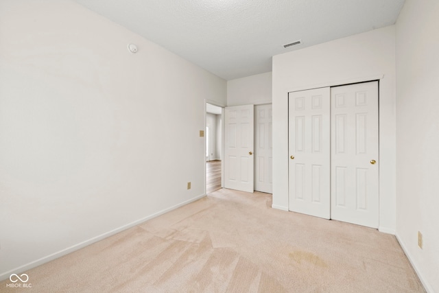 unfurnished bedroom with light colored carpet