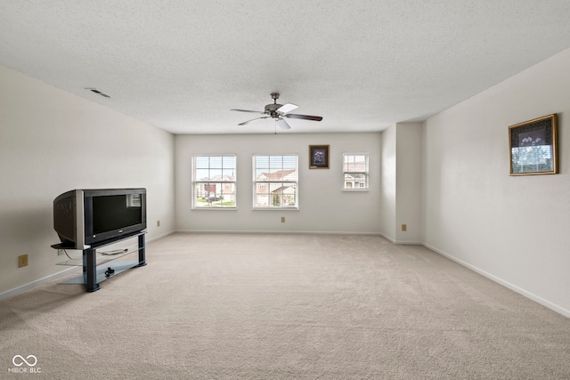 carpeted living room with ceiling fan and a textured ceiling