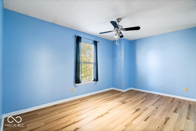 empty room with a textured ceiling, light hardwood / wood-style floors, and ceiling fan