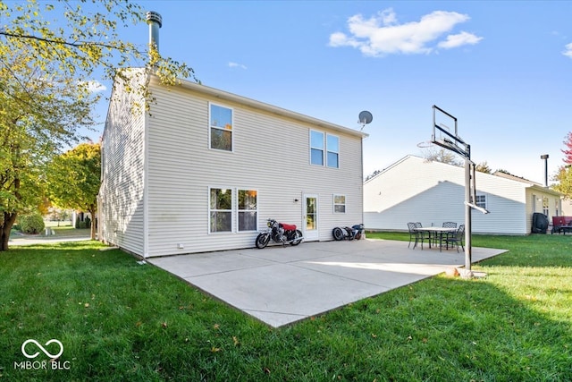 rear view of house featuring a lawn and a patio area