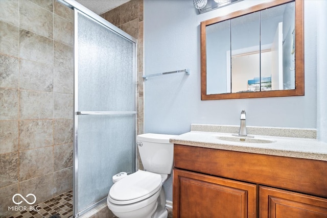 bathroom featuring vanity, toilet, and walk in shower