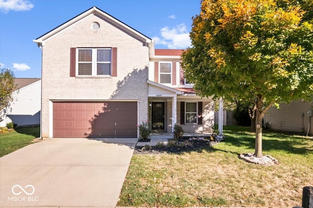 view of property with a front yard and a garage