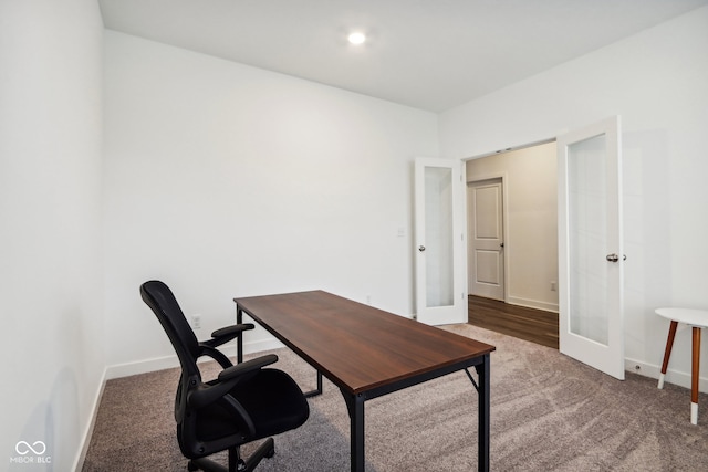 carpeted home office with french doors