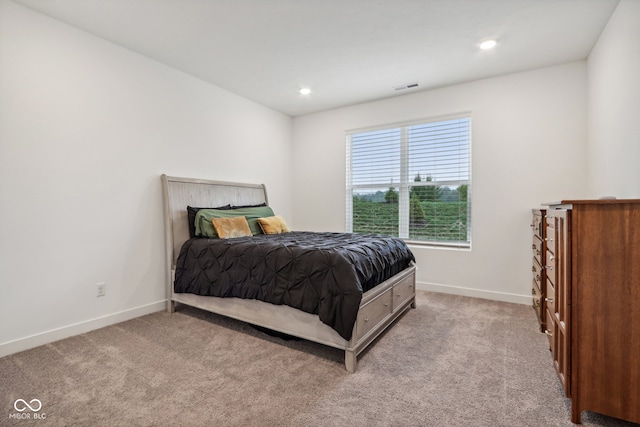 bedroom with light colored carpet