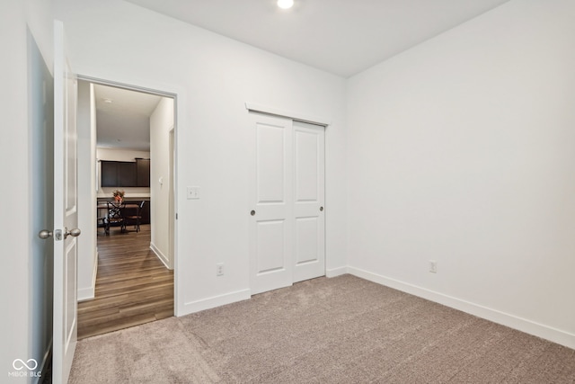 unfurnished bedroom featuring a closet and carpet floors