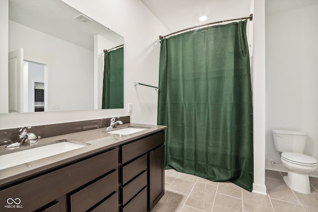 bathroom with curtained shower, tile patterned flooring, vanity, and toilet