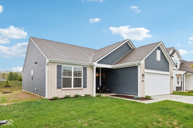 view of front of home with a front yard and a garage