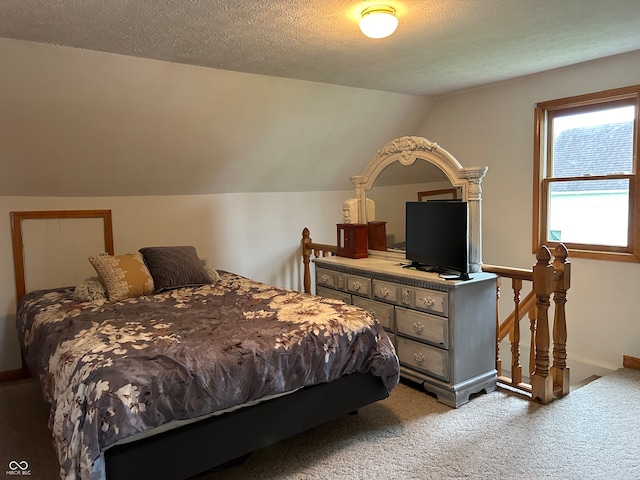 bedroom with carpet floors, a textured ceiling, and vaulted ceiling