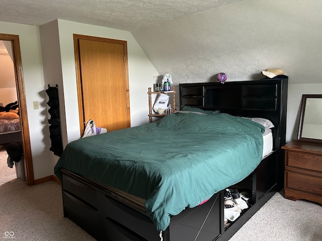 bedroom with light carpet, vaulted ceiling, and a textured ceiling