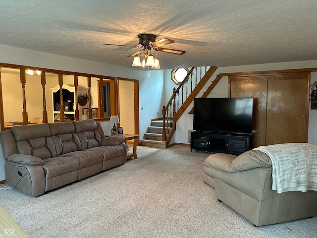 carpeted living room featuring a textured ceiling and ceiling fan