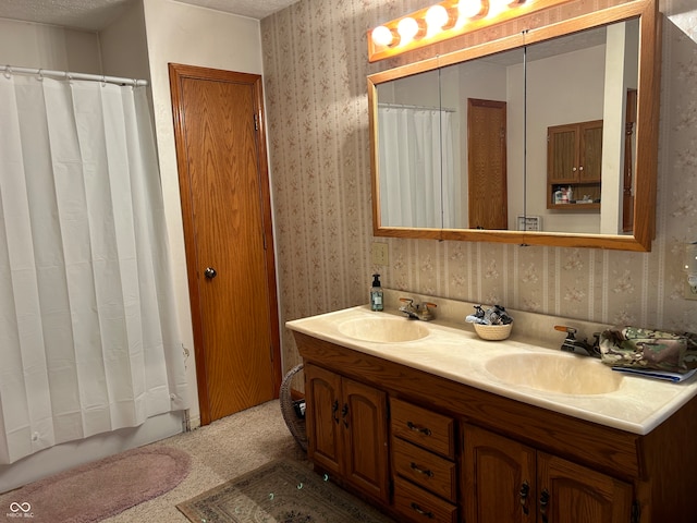 bathroom with a textured ceiling, vanity, and a shower with curtain