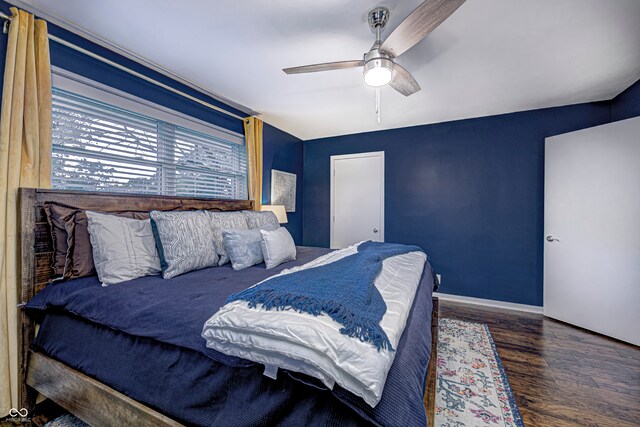 bedroom with vaulted ceiling, ceiling fan, and dark hardwood / wood-style floors