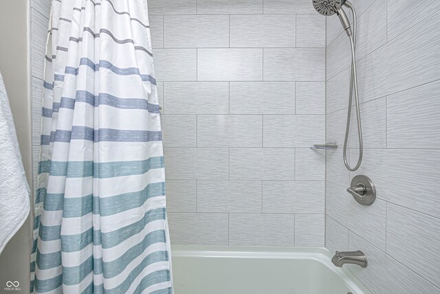 bathroom with shower / bathtub combination with curtain