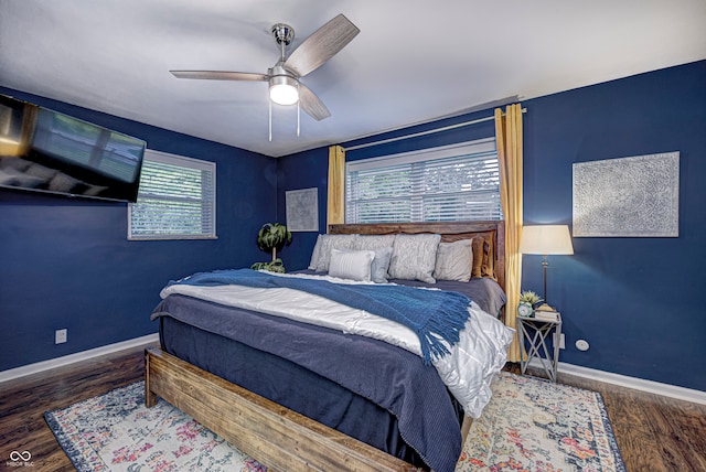 bedroom with dark hardwood / wood-style floors and ceiling fan