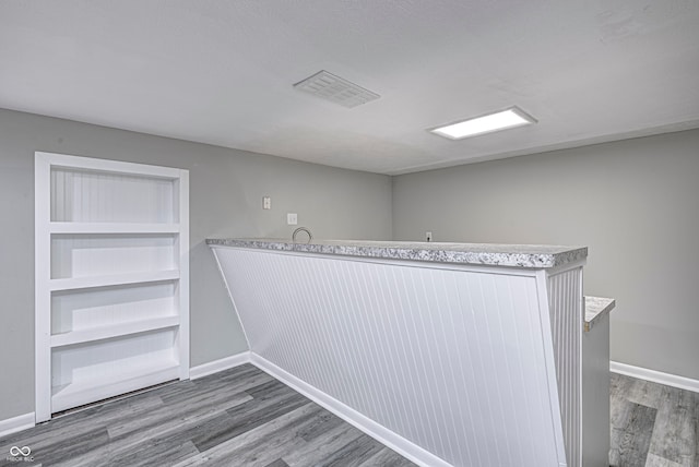 walk in closet with wood-type flooring